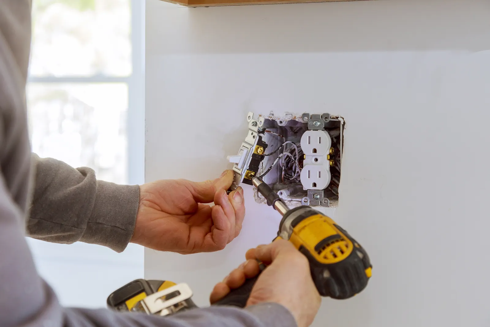 Electrician installing wall outlet 1600