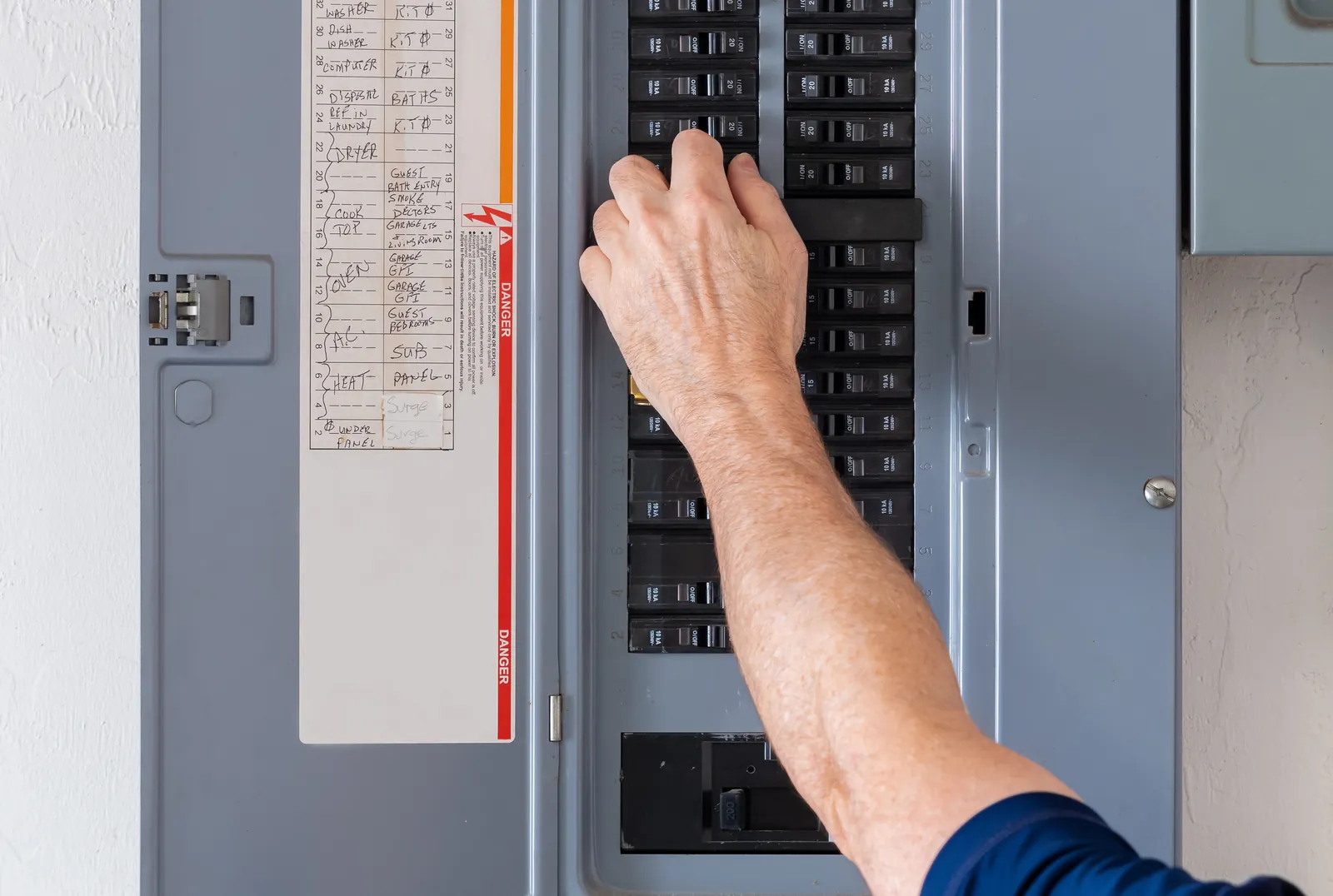 Hand at residential breaker panel 1600